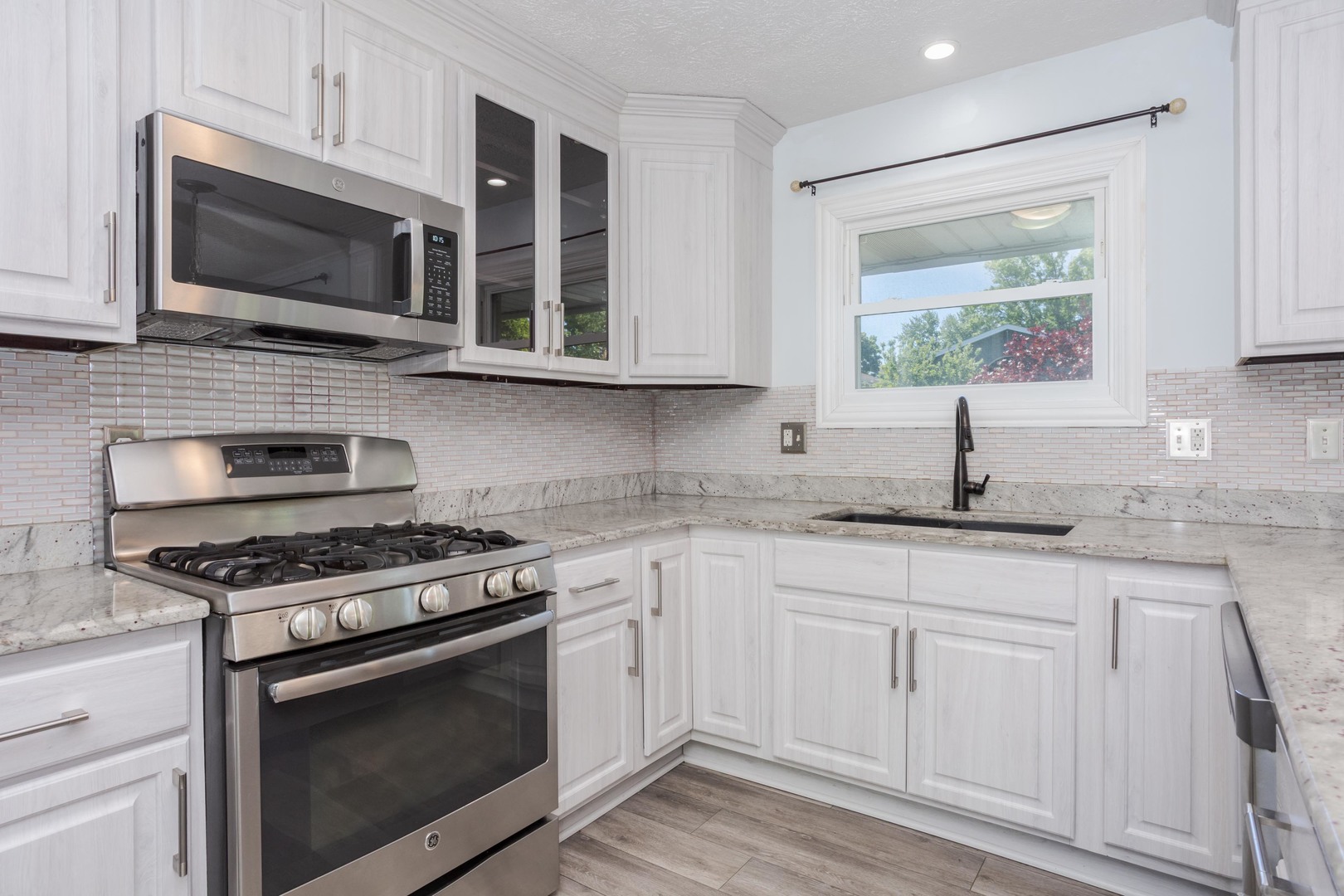 1717 Cook Drive Normal, IL 61761 - Photo 9 of 55 a kitchen with stainless steel appliances granite countertop a stove microwave and sink