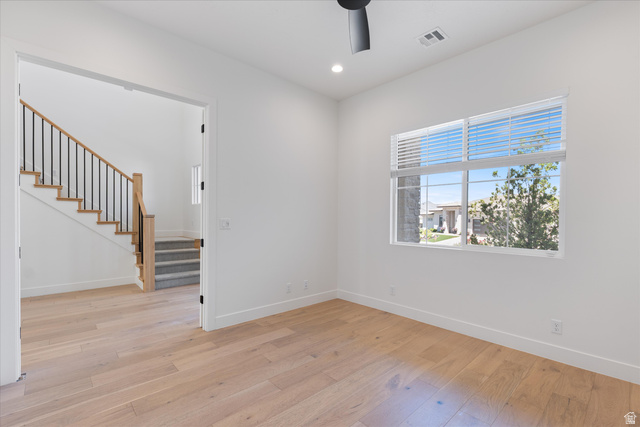1192 East Corral Way Washington, UT 84780 - Photo 13 of 81 Bright room featuring wide plank wood-finish flooring, a contemporary ceiling fan, and a large window with blinds