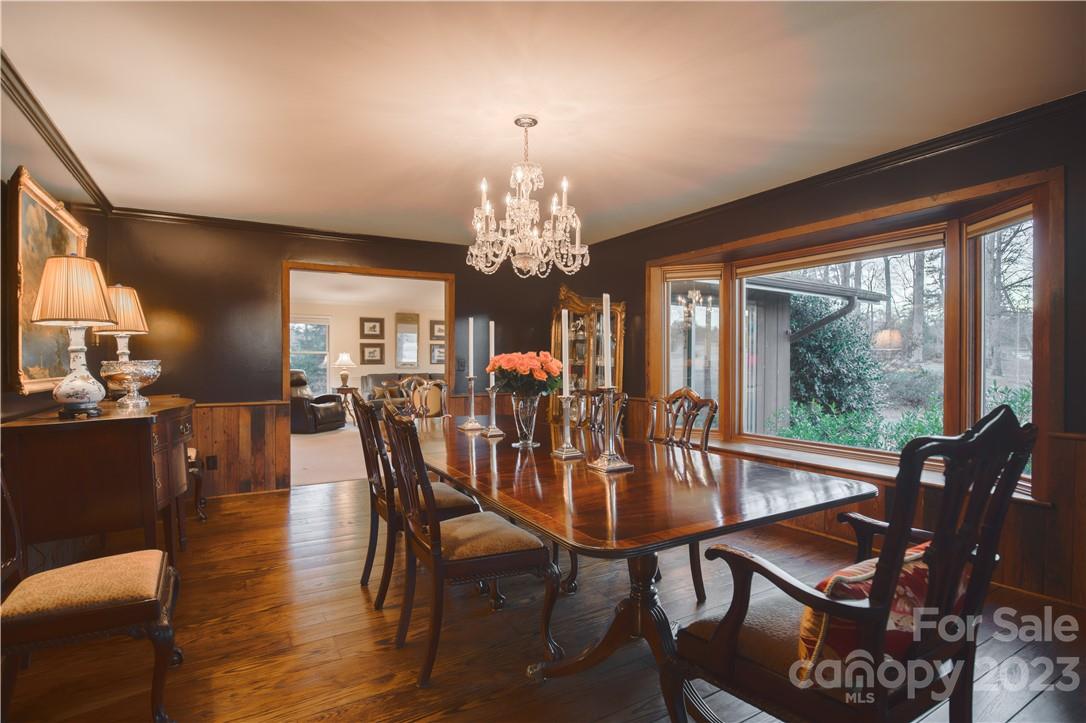 205 Hooper Creek Road Tryon, NC 28782 - Photo 12 of 45 a view of a dining room with furniture a chandelier and wooden floor
