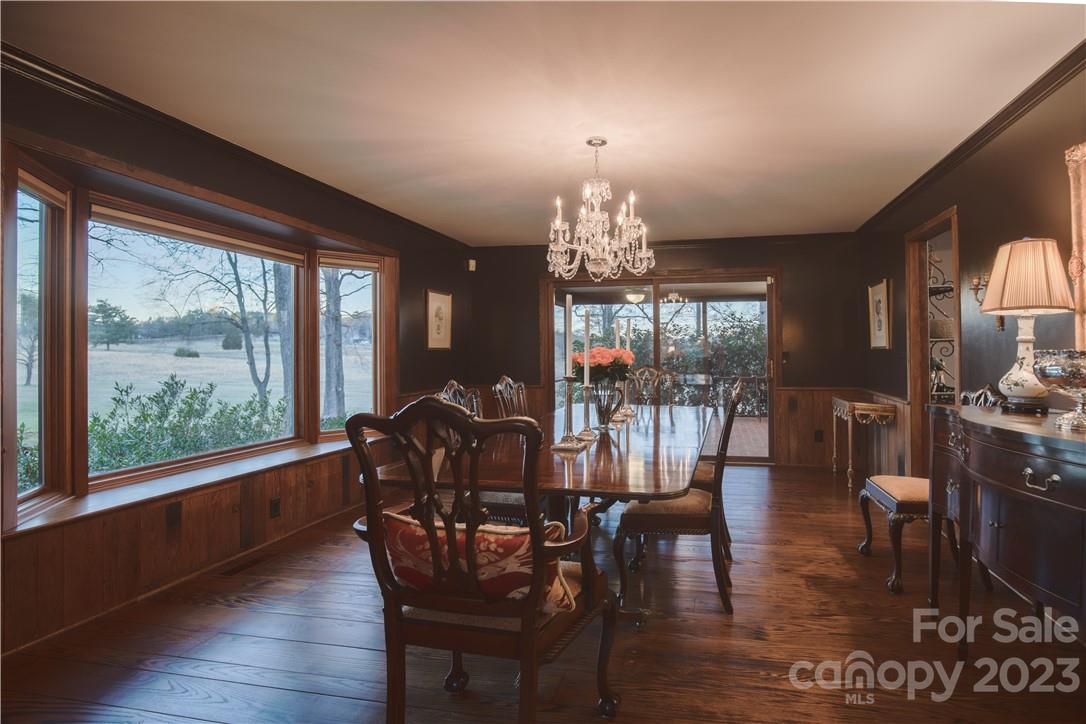 205 Hooper Creek Road Tryon, NC 28782 - Photo 13 of 45 a view of a dining room with furniture window and wooden floor