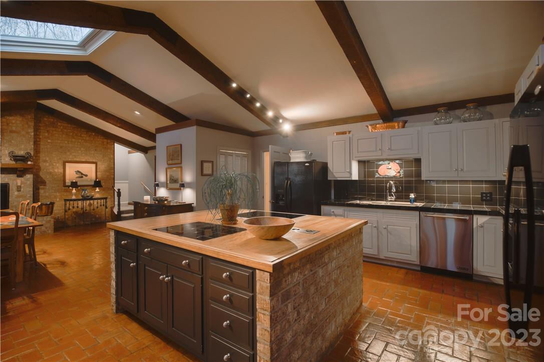 205 Hooper Creek Road Tryon, NC 28782 - Photo 15 of 45 a kitchen with sink a counter and cabinets