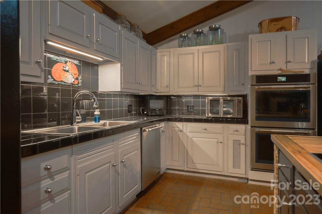 205 Hooper Creek Road Tryon, NC 28782 - Photo 18 of 45 a kitchen with appliances a sink and cabinets