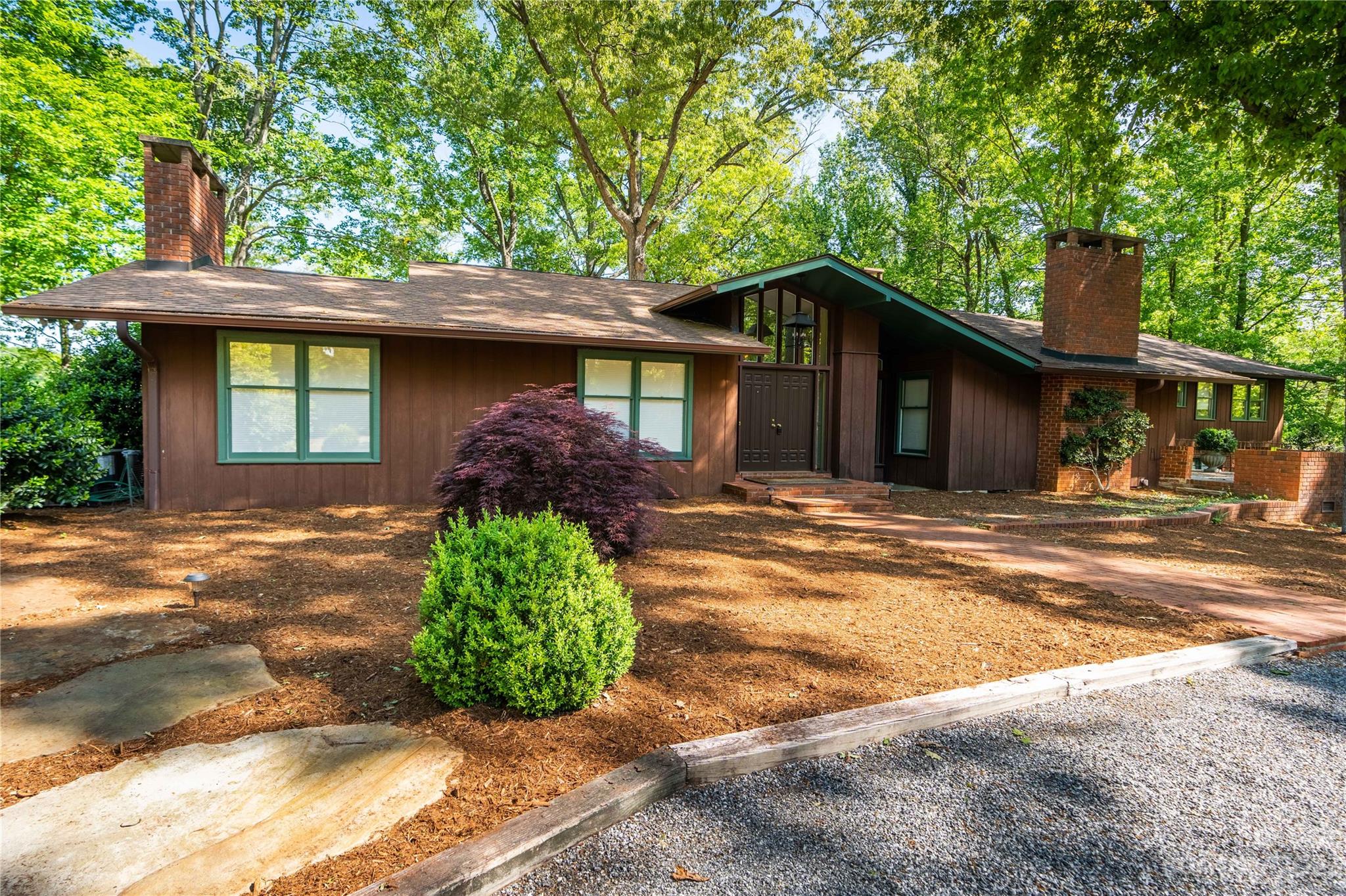 205 Hooper Creek Road Tryon, NC 28782 - Photo 2 of 45 a front view of a house with garden