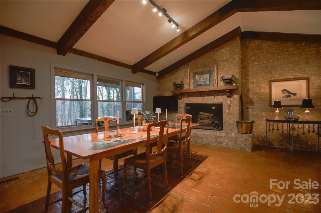 205 Hooper Creek Road Tryon, NC 28782 - Photo 21 of 45 a dining room with furniture window and wooden floor
