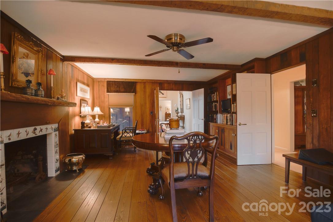 205 Hooper Creek Road Tryon, NC 28782 - Photo 24 of 45 a living room with furniture a fireplace and a dining table with wooden floor