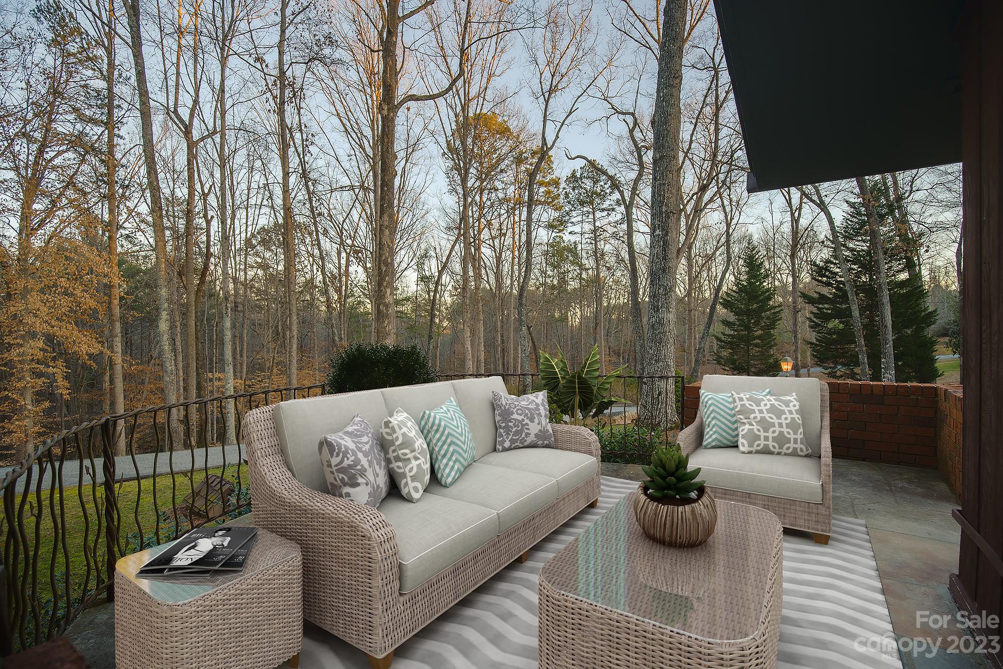 205 Hooper Creek Road Tryon, NC 28782 - Photo 27 of 45 a view of a patio with couches and potted plants