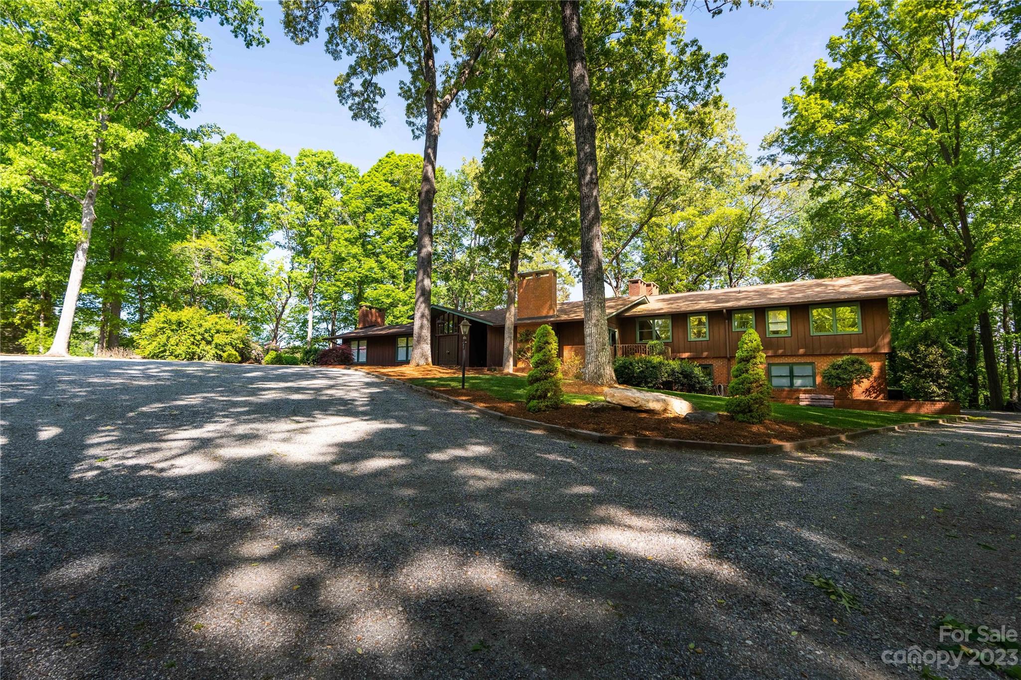205 Hooper Creek Road Tryon, NC 28782 - Photo 3 of 45 a front view of a house with a yard and trees