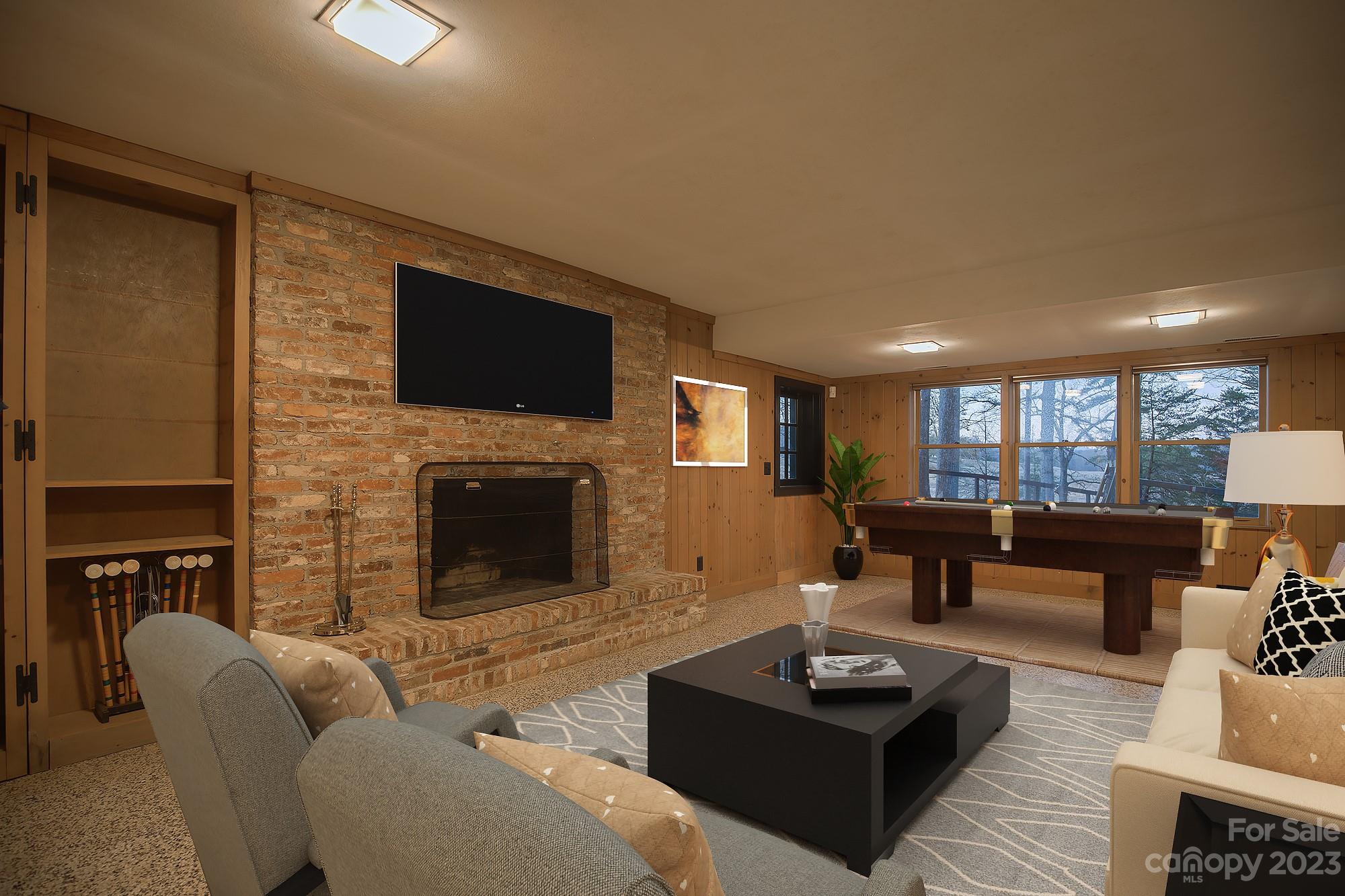 205 Hooper Creek Road Tryon, NC 28782 - Photo 41 of 45 a living room with furniture a fireplace and a flat screen tv