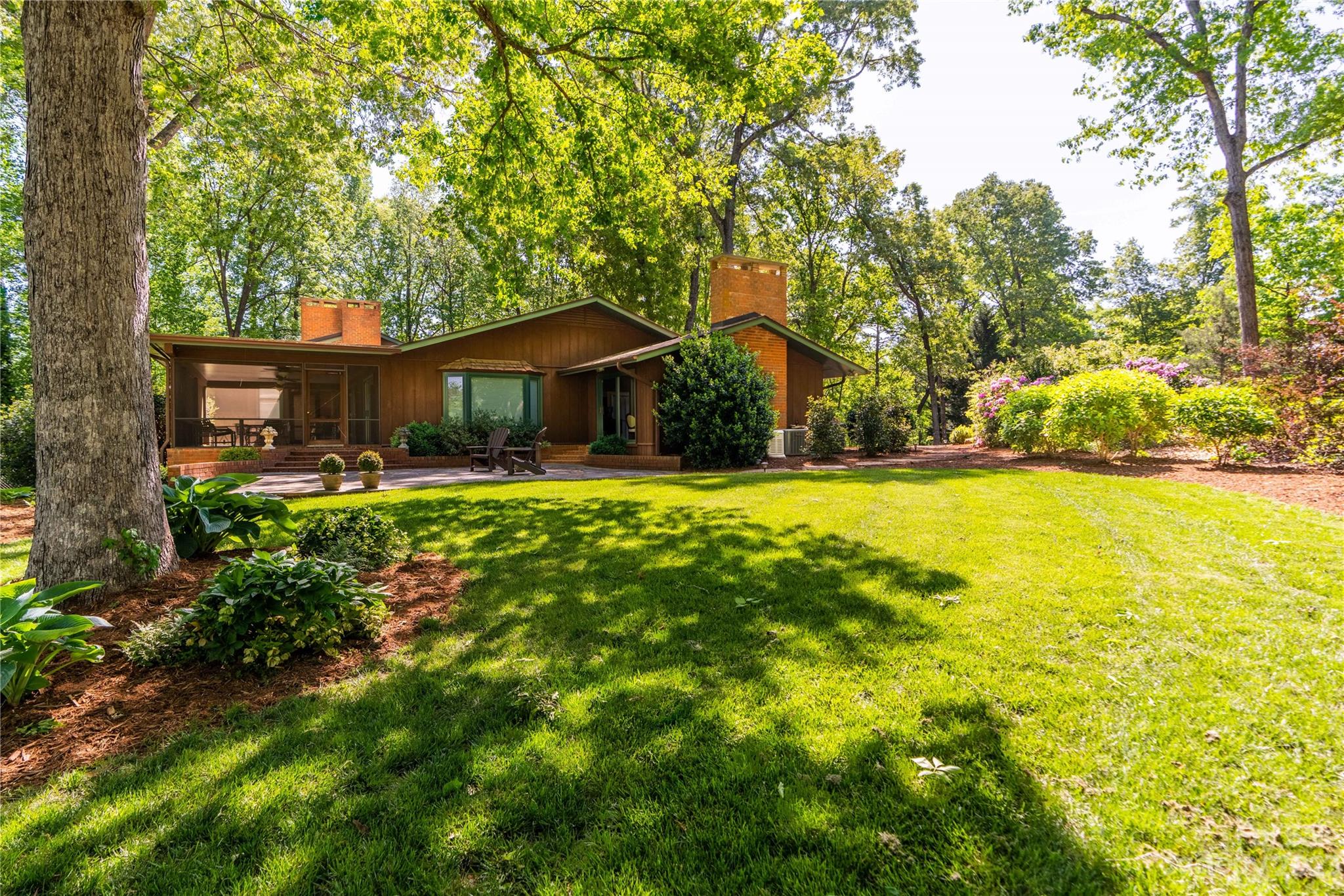 205 Hooper Creek Road Tryon, NC 28782 - Photo 6 of 45 a front view of a house with garden