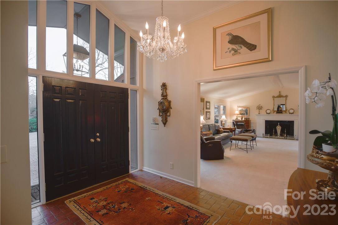205 Hooper Creek Road Tryon, NC 28782 - Photo 8 of 45 a view of a livingroom with furniture a chandelier and wooden floor