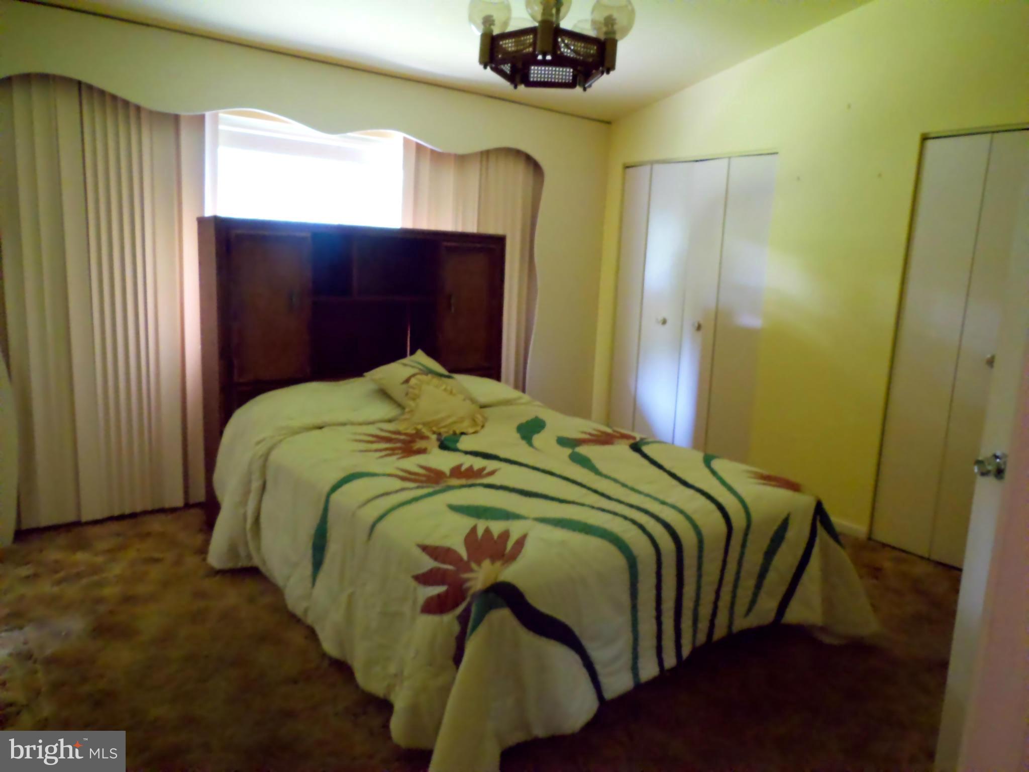 7419 Prince George Road Baltimore, MD 21208 - Photo 13 of 19 a bedroom with a bed and a mirror