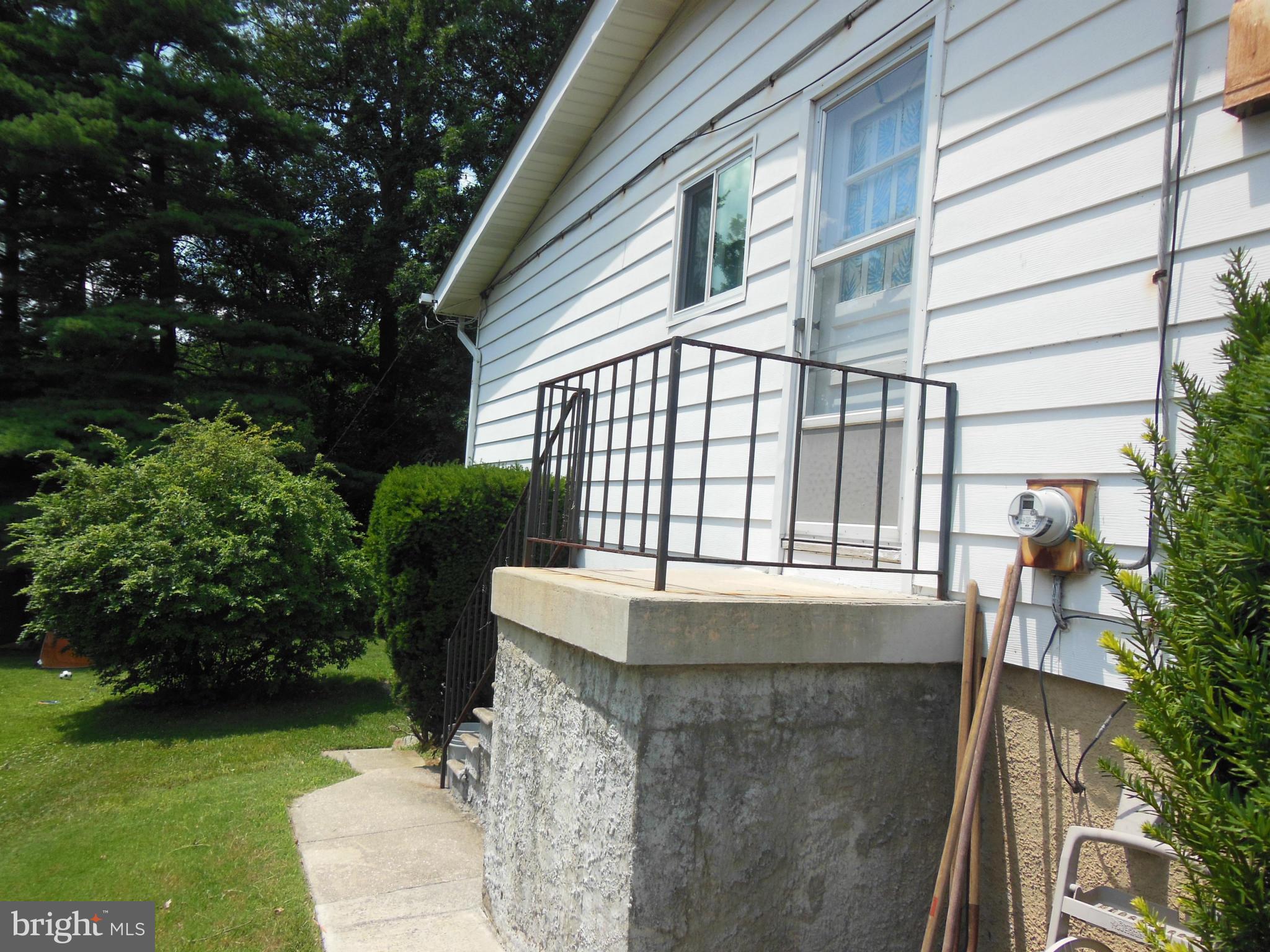 7419 Prince George Road Baltimore, MD 21208 - Photo 4 of 19 a front view of a house with garden