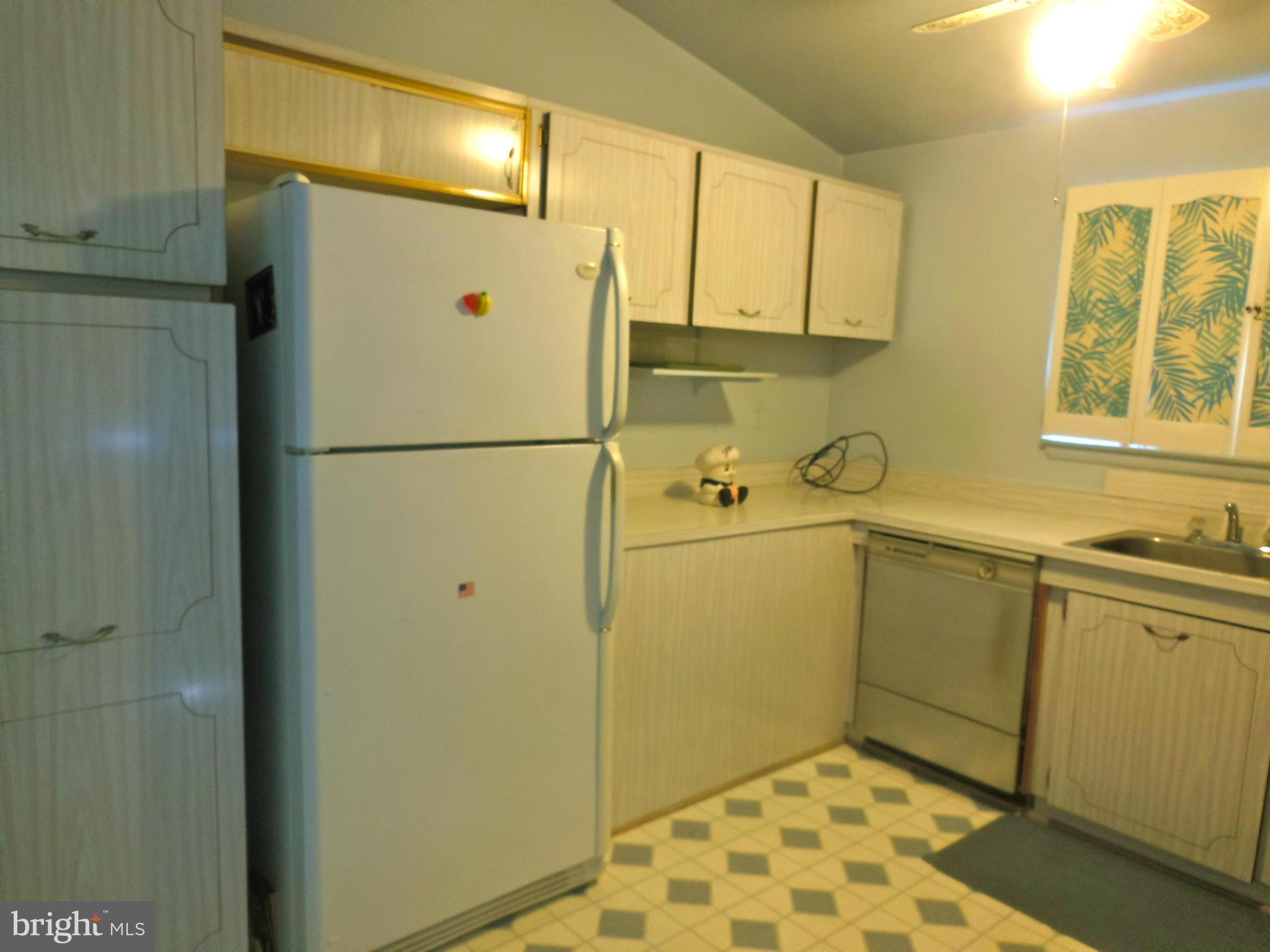7419 Prince George Road Baltimore, MD 21208 - Photo 10 of 19 a white refrigerator freezer sitting inside of a kitchen