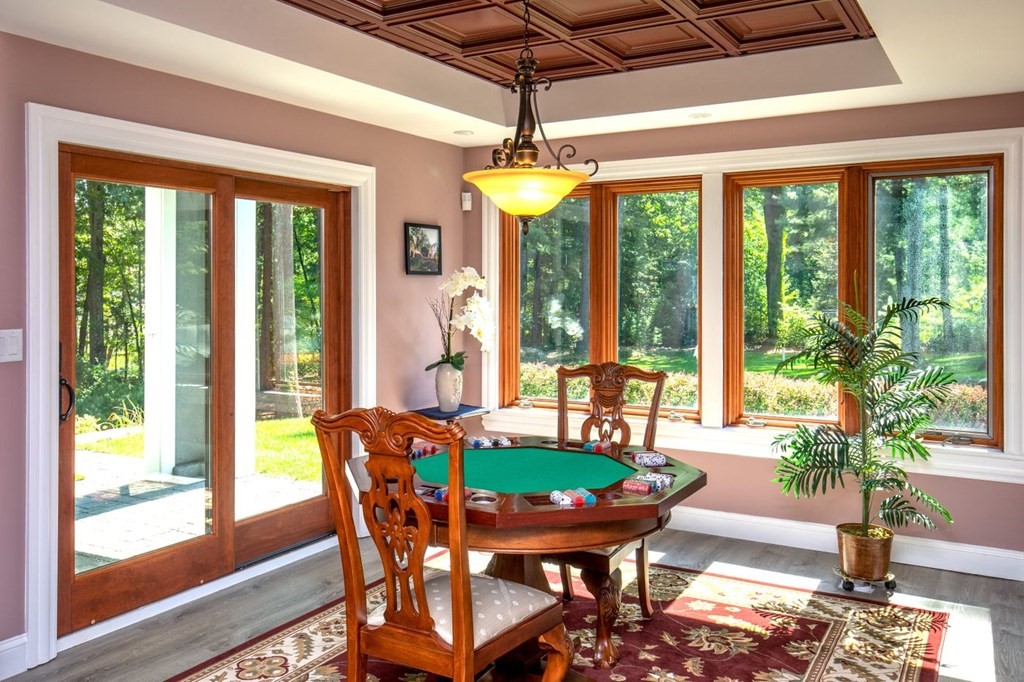 49 Wilsondale Street Dover, MA 02030 - Photo 16 of 22 a dining room with furniture a chandelier and wooden floor