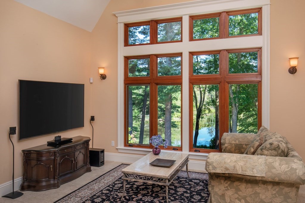 49 Wilsondale Street Dover, MA 02030 - Photo 22 of 22 a living room with furniture a flat screen tv and a floor to ceiling window