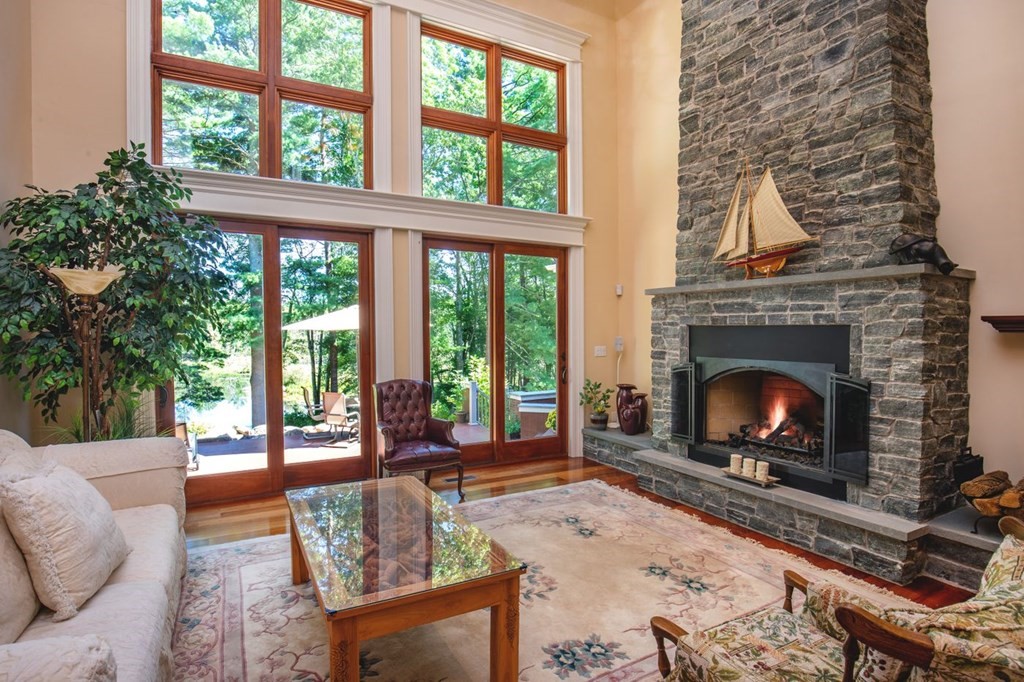 49 Wilsondale Street Dover, MA 02030 - Photo 6 of 22 a living room with furniture a fireplace and a floor to ceiling window
