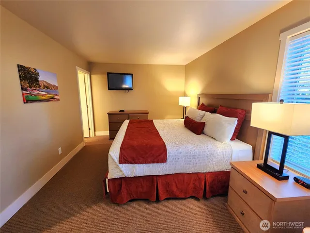 a bedroom with a bed and lamp