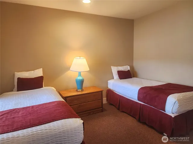 a bedroom with a bed and a lamp