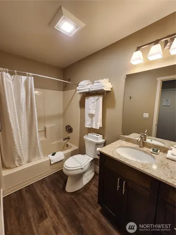 a bathroom with a sink vanity mirror and toilet