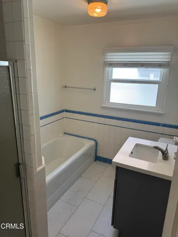a bathroom with a tub sink and vanity