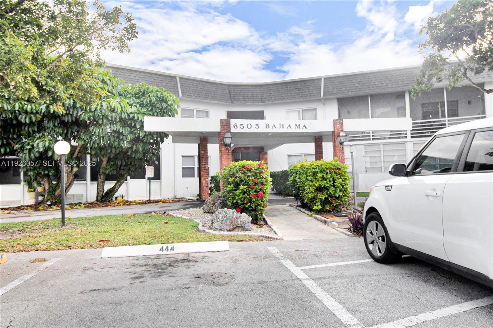 6505 Winfield Boulevard, Unit B4 Margate, FL 33063 - Photo 1 of 25 a car parked in front of house with yard