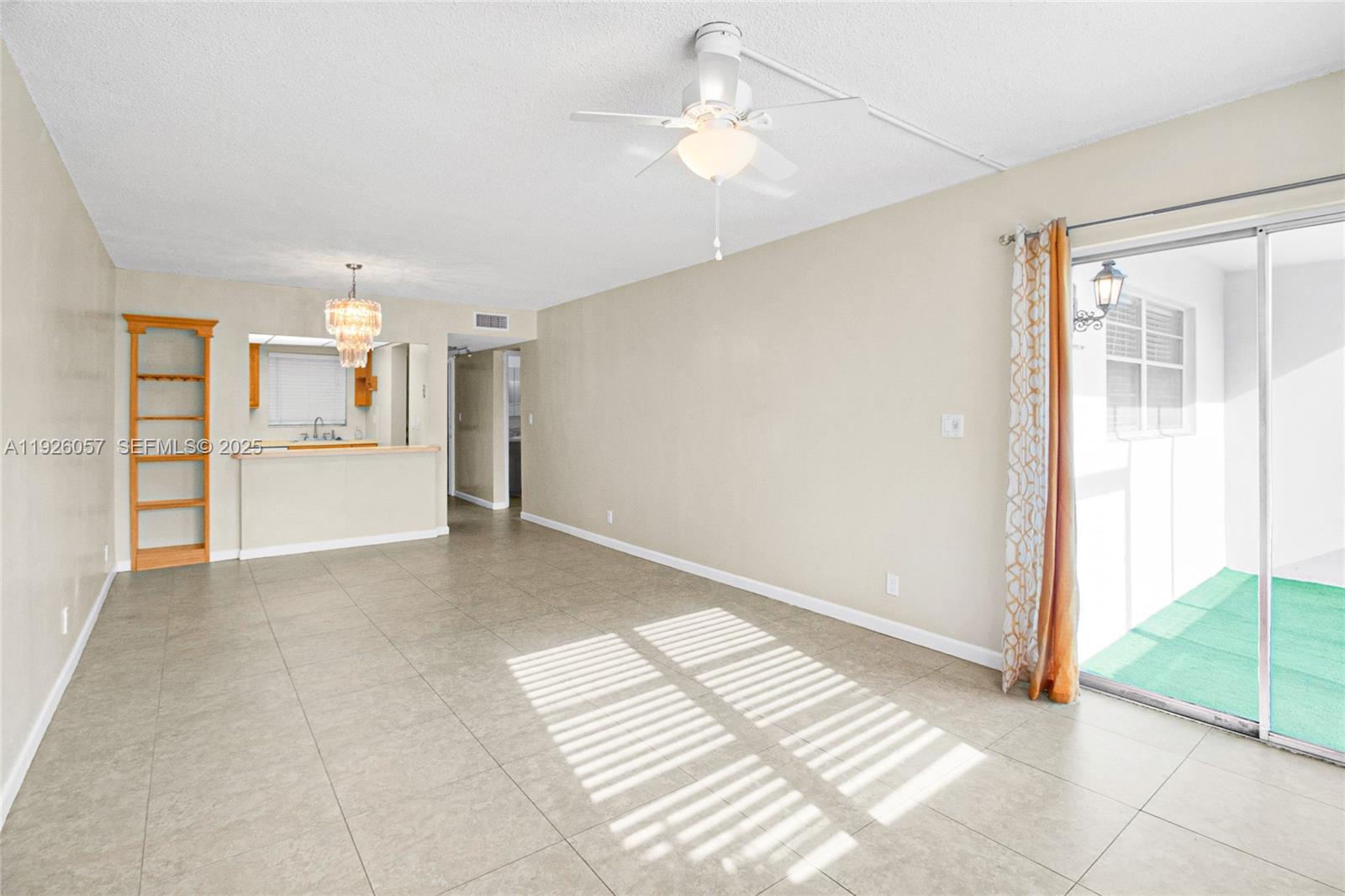 6505 Winfield Boulevard, Unit B4 Margate, FL 33063 - Photo 11 of 25 a view of an empty room with a window and kitchen view
