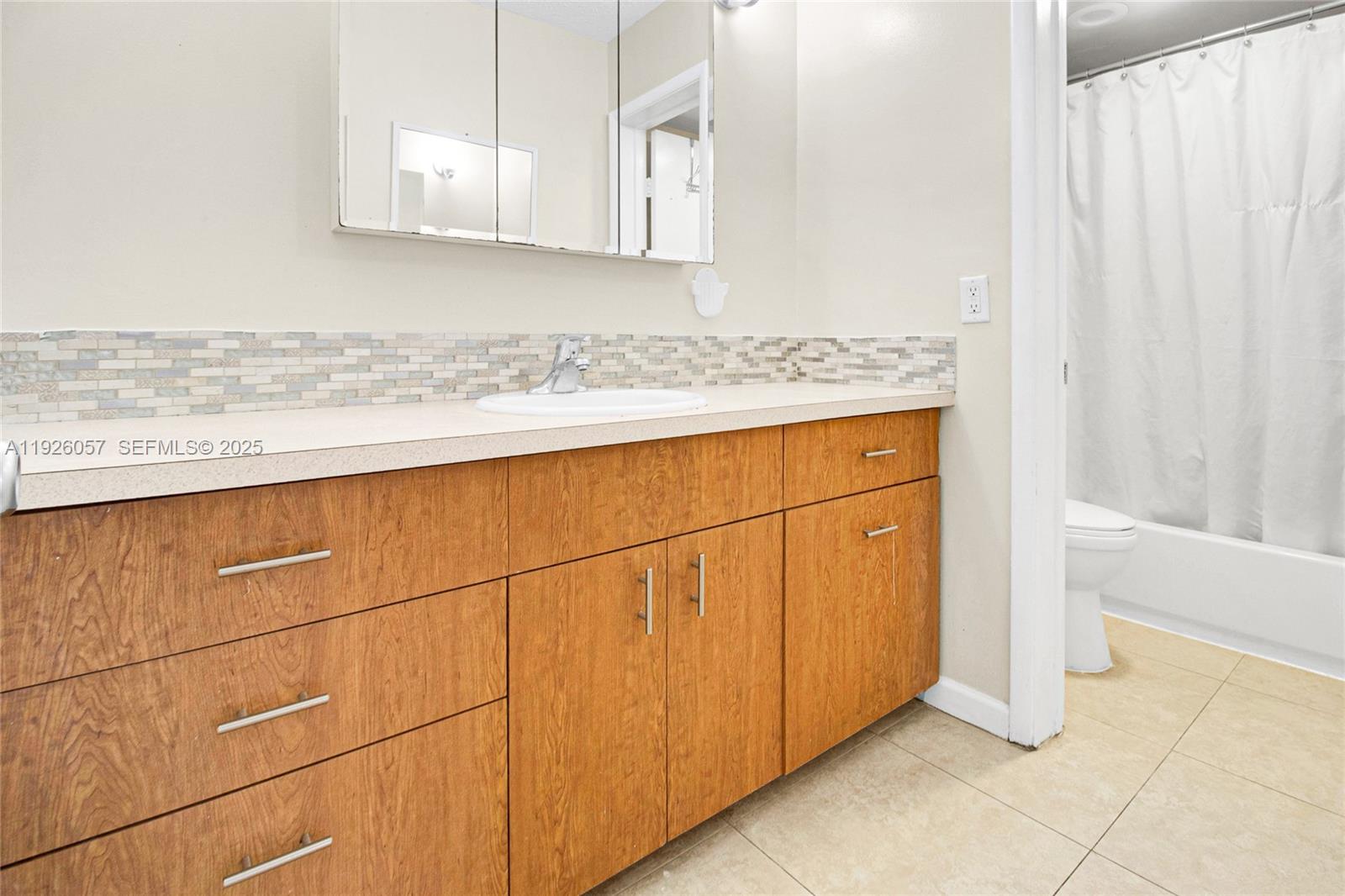 6505 Winfield Boulevard, Unit B4 Margate, FL 33063 - Photo 13 of 25 a bathroom with a granite countertop sink and a mirror