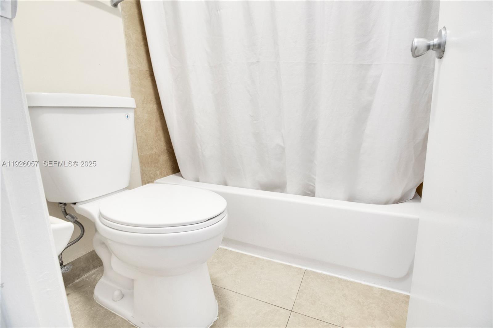 6505 Winfield Boulevard, Unit B4 Margate, FL 33063 - Photo 14 of 25 a white toilet sitting next to a small sink
