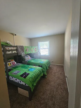 a bed room with a bed and a window
