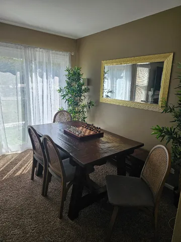 a view of a dining room with furniture and window
