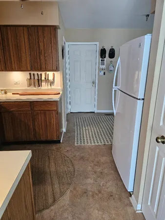 a kitchen with a refrigerator sink and cabinets