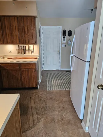 a kitchen with a refrigerator sink and cabinets