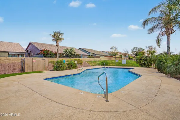 a swimming pool with some trees in the background