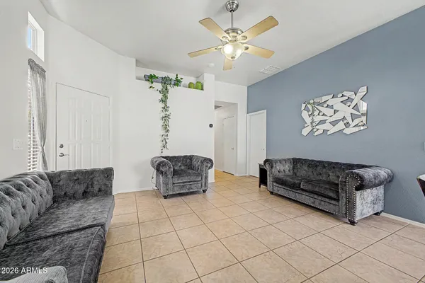 a living room with furniture and a chandelier
