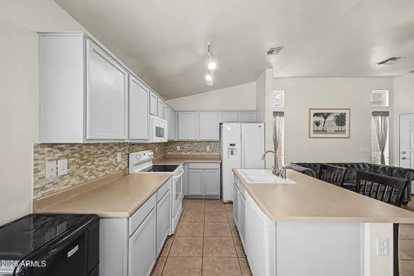 a kitchen with a sink stove and refrigerator