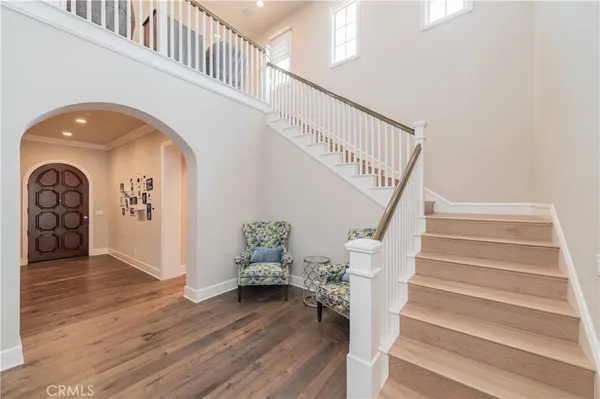 a view of entryway and hall with wooden floor