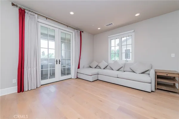 a living room with furniture and a floor to ceiling window