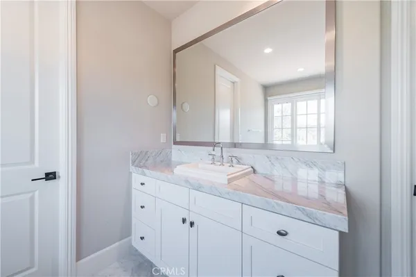 a bathroom with a granite countertop sink mirror and double