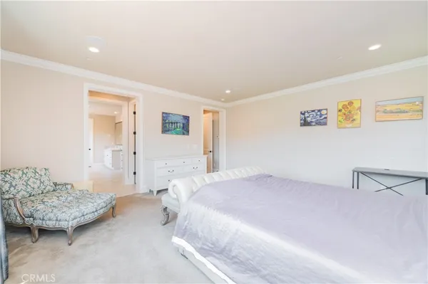 a spacious bedroom with a bed and a couch