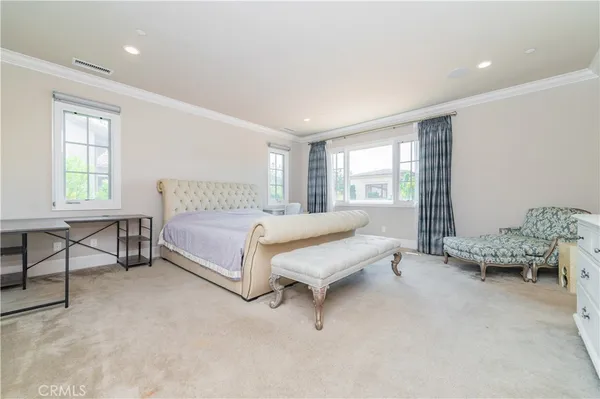 a spacious bedroom with a bed and a couch