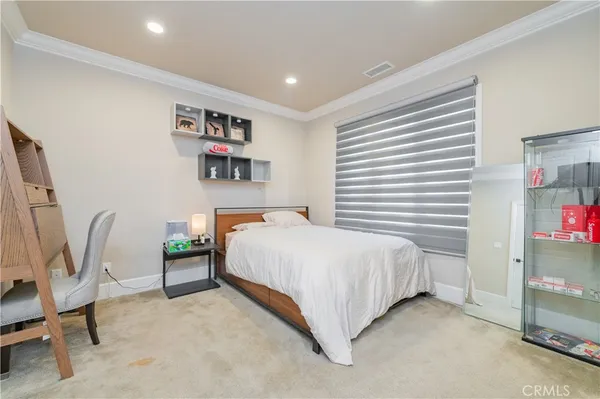 a bedroom with a bed a desk and chair