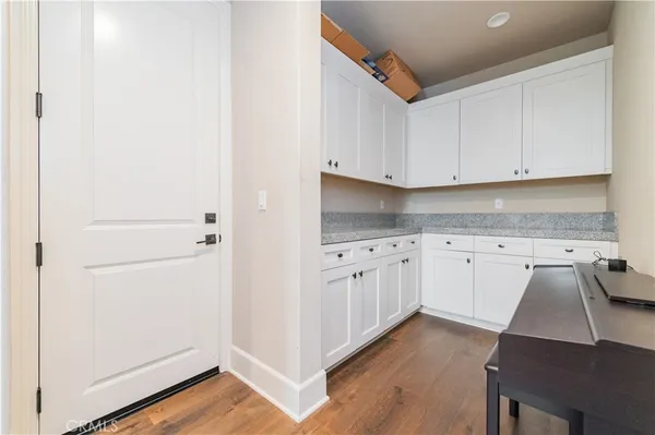 a kitchen with granite countertop white cabinets and white appliances