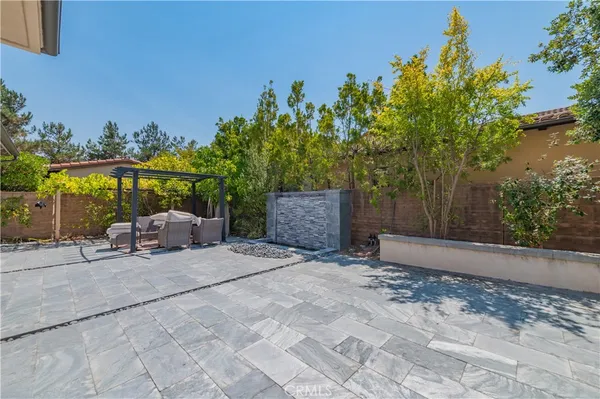 a backyard of a house with lots of green space and outdoor seating