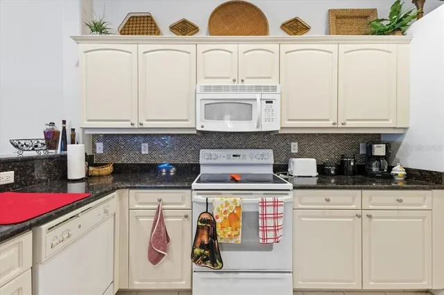 a kitchen with stainless steel appliances kitchen island granite countertop a sink and cabinets