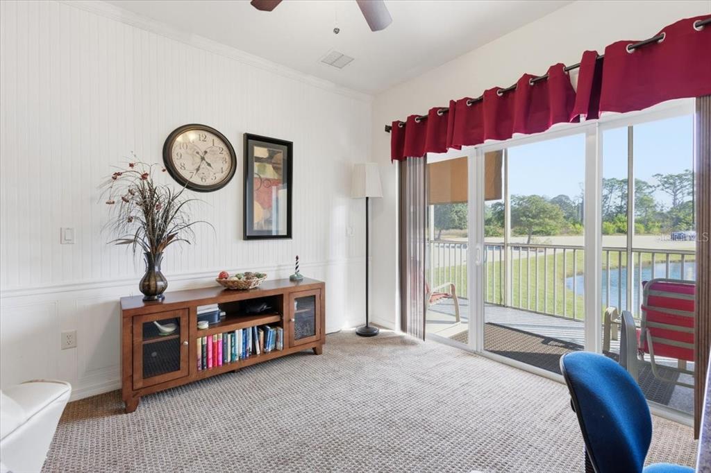 102 Natures Way, Unit 2101 Rotonda West, FL 33947 - Photo 22 of 49 a living room with furniture a bed and a large window