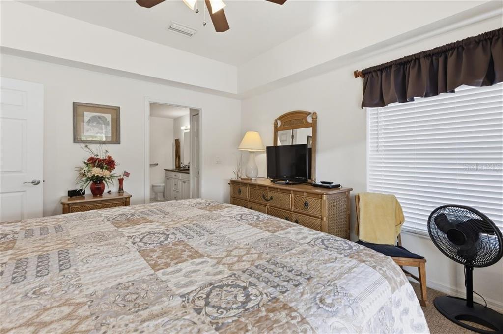 102 Natures Way, Unit 2101 Rotonda West, FL 33947 - Photo 24 of 49 a bedroom with a bed and a television on desk