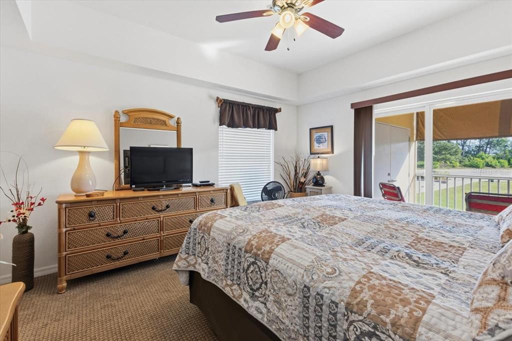 102 Natures Way, Unit 2101 Rotonda West, FL 33947 - Photo 25 of 49 a spacious bedroom with a bed and a flat screen tv