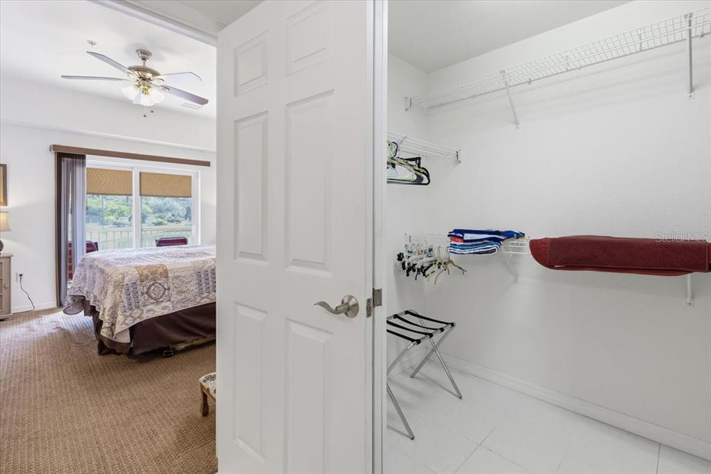 102 Natures Way, Unit 2101 Rotonda West, FL 33947 - Photo 28 of 49 a bedroom with a bed and a chandelier