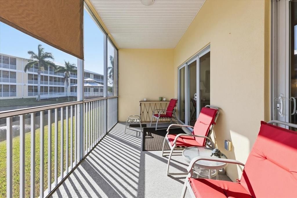 102 Natures Way, Unit 2101 Rotonda West, FL 33947 - Photo 30 of 49 a view of a balcony with chair and tables