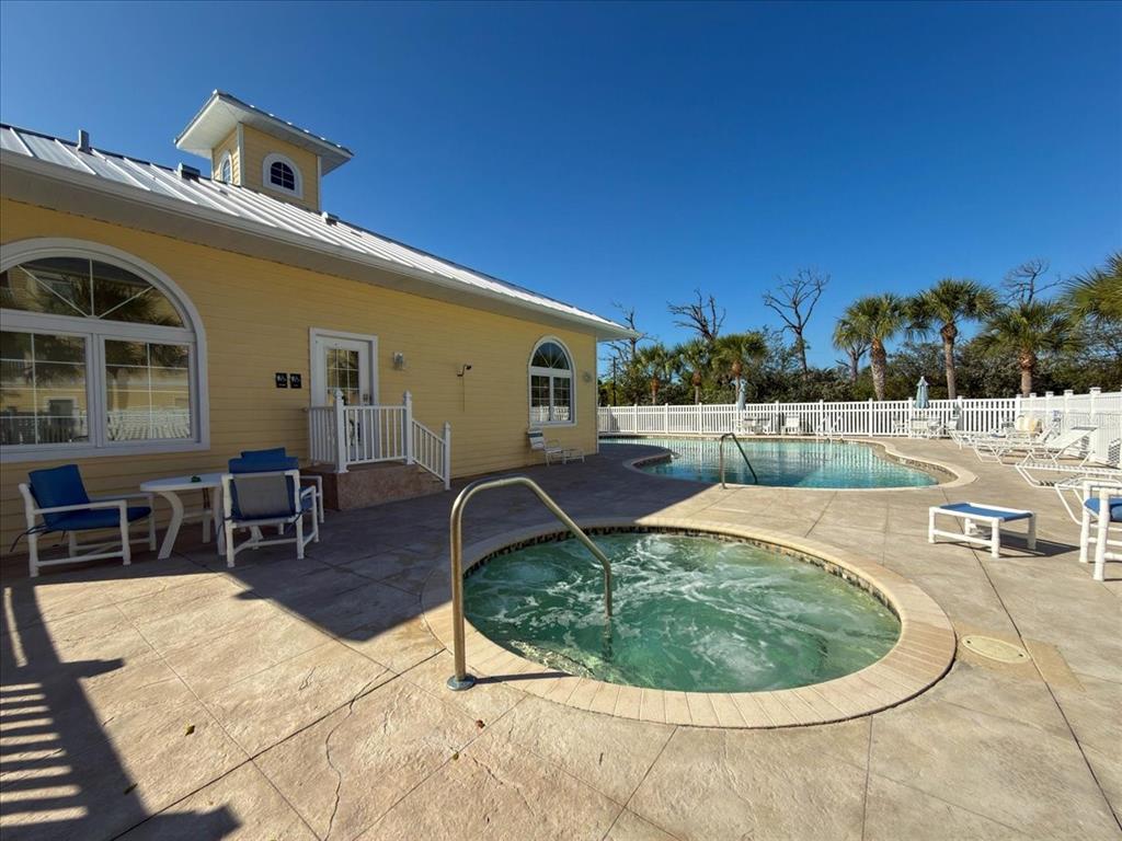 102 Natures Way, Unit 2101 Rotonda West, FL 33947 - Photo 35 of 49 a roof deck with table and chairs